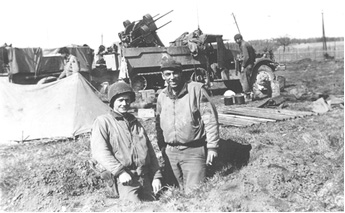 1st Sgt. Beavers and Sgt. Stout with self-propelled anti-aircraft artillery vehicles behind them